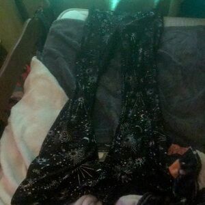 Black pair of flared leggings with suns, moons, and stars.